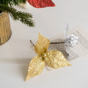 Glittery gold and silver Christmas tree picks on a festive background for DIY holiday decor