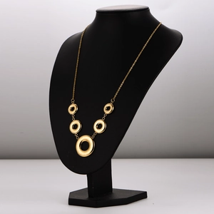 Golden stainless steel necklace with interconnected hollow circles on a black mannequin