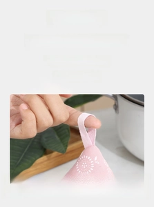 Pink floral fabric lid holder featuring a convenient lanyard for hanging storage