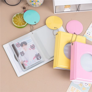 Close-up of macaron color mini photo albums with hollow round window and ball chain