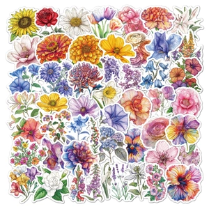 Flat lay detail of floral holographic stickers including sunflowers and roses with white edges