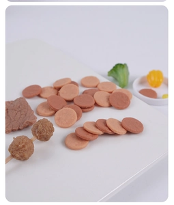 Macro shot of miniature meat patties and food skewers for dollhouse play kitchen