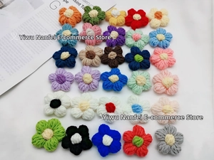 Flat lay of colorful handmade crochet milk cotton flower patches for DIY accessories