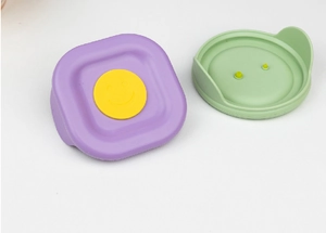 Detail view of colorful silicone seals and air vent buttons for glass food containers