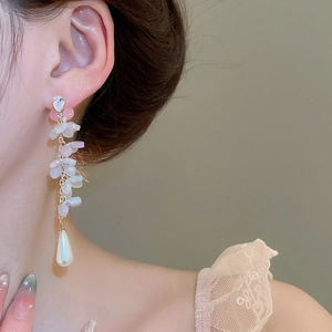 Close-up of elegant floral tassel earrings with pink petals and white teardrop pearls