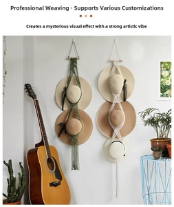 Detail of bohemian woven cotton rope hat organizer with wooden rod in home setting