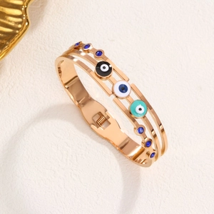 Three-layer gold evil eye bangle with blue enamel and sparkling zircon accents