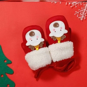 Detail of red baby Christmas mittens with white faux fur and cute reindeer cartoon