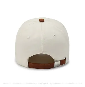 Detail view of cotton baseball cap back with brown adjustable strap and silver metal buckle
