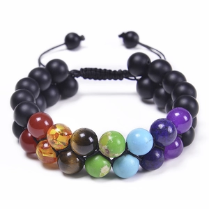 Macro detail of double-layer bead bracelet with 7 chakra stones and adjustable black cord