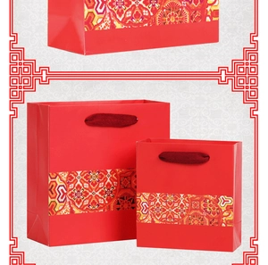Three sizes of red ethnic style paper gift bags with golden Japanese style pattern bands