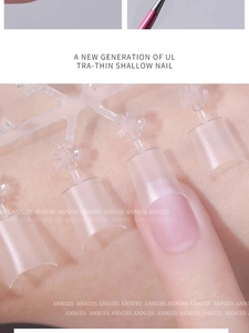 Close-up of ultra-thin transparent shallow crescent nail tips on a model finger