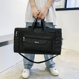 Detail of a large black nylon travel bag with S SPORT logo and adjustable shoulder strap