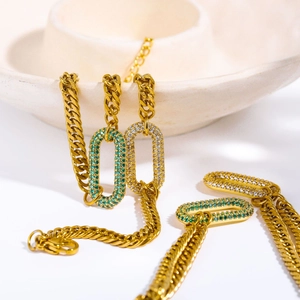 Detail of gold-plated Cuban link chain with green and white rhinestone centerpiece