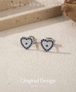 Macro shot of S925 sterling silver heart earrings with blue crystals and hallmark