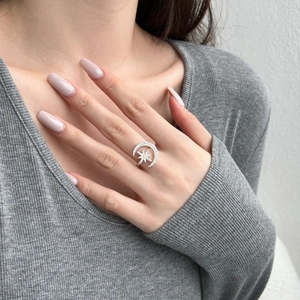 Close-up of S925 silver ring featuring moon and star shapes with pavé zircon stones