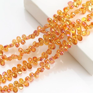 Close-up of faceted amber crescent crystal pendants for DIY jewelry and necklaces