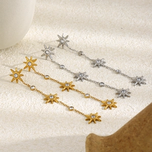 Minimalist 18K gold and silver star tassel earrings with zircon in a creative display