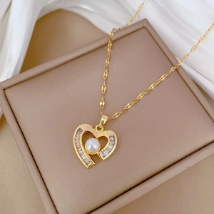 Detail of gold heart pendant necklace with pearls and crystals on a silk background