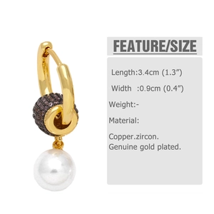 Detail view of pearl drop hoop earring with golden base and brown zircon inlay