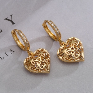 Gold plated hollow heart earrings with zircon inlay and floral patterns on grey background