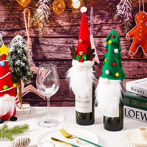 Festive Christmas gnome wine bottle covers featuring reindeer antlers and tree hat designs