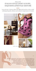 Detail of pink silk-like satin nightgown with black heart patterns and delicate lace trim