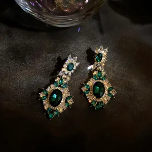 Detailed macro view of vintage emerald green earrings with luxury zircon crystal setting