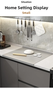 Macro shot of stainless steel kneading board with bended edge in a modern kitchen
