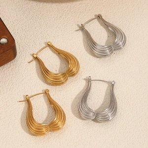 Fashionable wave pattern heart hoop earrings in gold and silver finishes for women