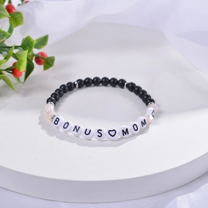 Detail of beaded bracelet with 6mm matte stones and BONUS MOM letter beads on display