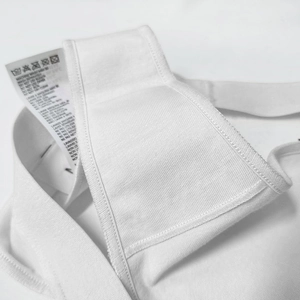 Close-up of white cotton V-cut panties showing breathable fabric and wash care label