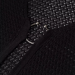 Detail of black hollow mesh knit dress featuring a silver metal ring buckle closure