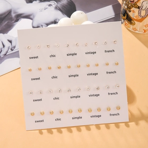 Set of 20 pairs of elegant gold ball and cubic zirconia stud earrings on white card