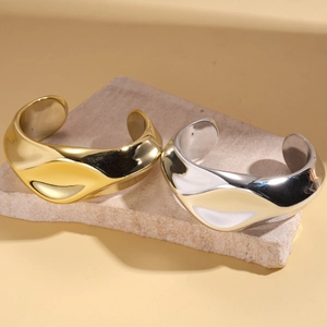 Minimalist irregular wave-shaped cuff bracelets in polished gold and silver finishes