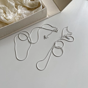 Close-up of S925 sterling silver hallmark on sleek snake chain necklace with gift box