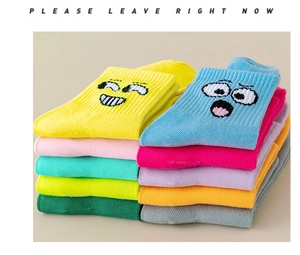 Macro shot of colorful knitted socks featuring expressive cartoon smiley faces