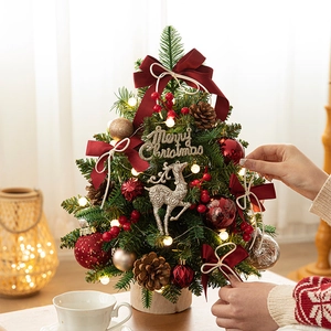 Mini pre-lit Christmas tree with red bows, pine cones and silver elk on wooden base