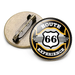 Detailed view of Route 66 badge showing front glass dome and bronze metal pin back