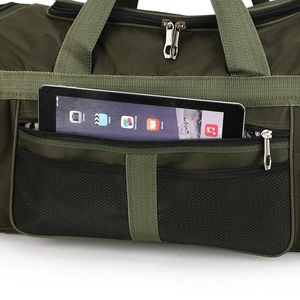 Close-up of green nylon travel bag featuring mesh pocket and durable metal zippers
