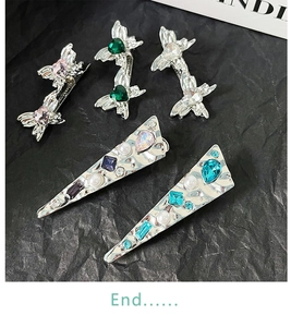 Detailed view of silver liquid metal bow hair clips with colorful heart rhinestones