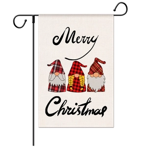 Close-up of linen Christmas garden flag with three gnomes and Merry Christmas text