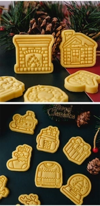 Detailed view of baked gingerbread cookies in fireplace and sled shapes for Christmas baking