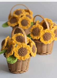 Detailed craftsmanship of three mini handmade crochet sunflower baskets with green leaves