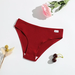 Close-up of ribbed cotton panties in deep red with high-quality stitching and brand tag
