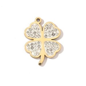 Detailed macro view of a gold four-leaf clover pendant with white inlay and crystals