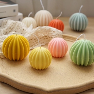 Detailed view of spherical candles with vertical ribbed texture in various pastel colors