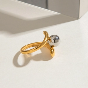 Detail of two-tone gold and silver beaded open ring with minimalist shadow effect