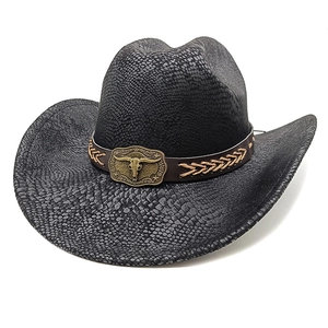 Detail of black cowboy hat featuring snake pattern texture and bronze bull head buckle