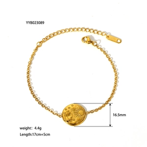 Detailed view of 18K gold-plated celestial sun and moon relief on stainless steel charm